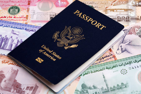 American passport on United Arab Emirates money - Dirhamの写真素材