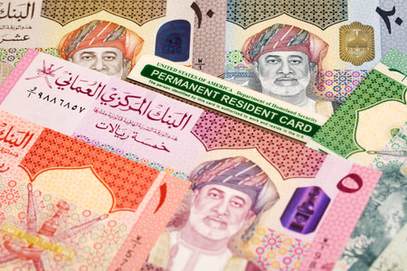 American permanent resident card on Omani money - Rialの写真素材