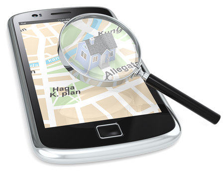 Black Smartphone with a GPS map with a 3D house and a Magnifying Glass.の写真素材