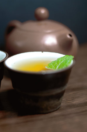 Asian teapot with sprigs of mint for teaの写真素材