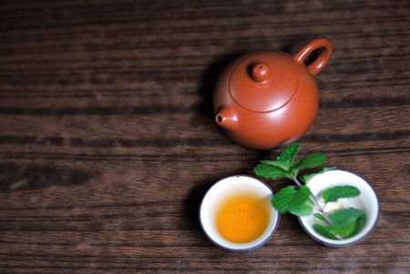 Asian teapot with sprigs of mint for teaの写真素材