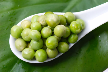 Green peas on the spoonの写真素材