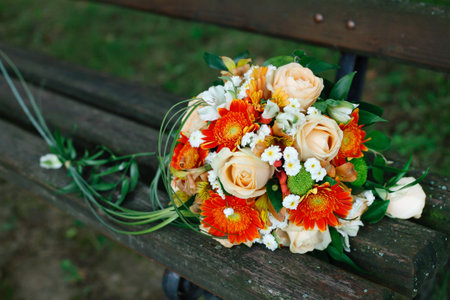 A wonderful bridal bouquet on a park bench.の写真素材