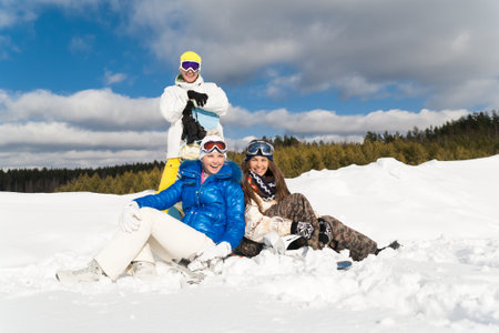 Young people are enjoying the sun and snow, wallowing in the snowの写真素材