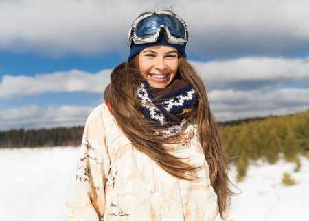 Young beautiful girl are enjoying the sun and snowの写真素材