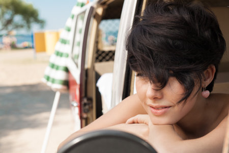 Woman relaxing in her car near the beach - outdoorsの写真素材