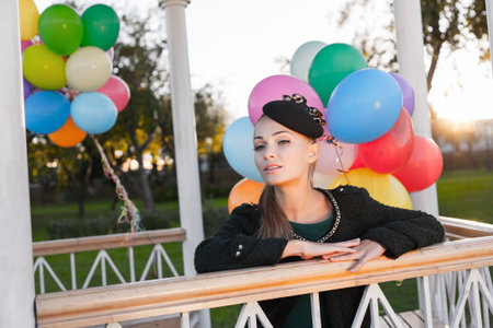 Portrait of a pretty woman sitting in a park against the sunset, outdoorsの写真素材
