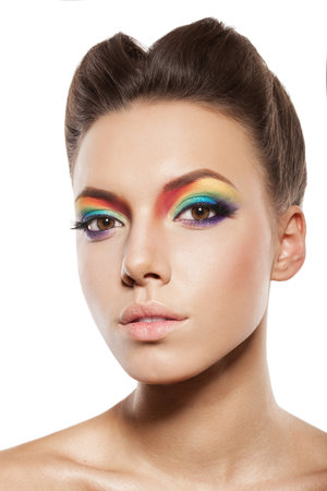 beautiful young woman face with rainbow makeupの写真素材