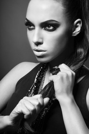 sexy woman with long hair, make-up and smokey eyes in black and whiteの写真素材