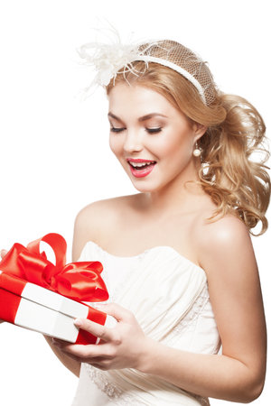 Beautiful blonde bride with white gift boxの写真素材