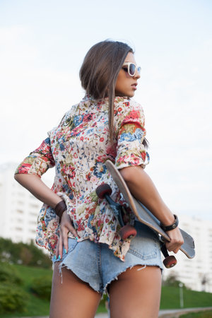 Girl with skateboard on a nice day  outdoorの写真素材