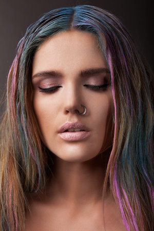 woman with multicoloured hair, indoorの写真素材
