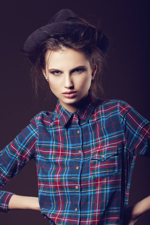 Woman with open lips in hat on dark background, indoorの写真素材