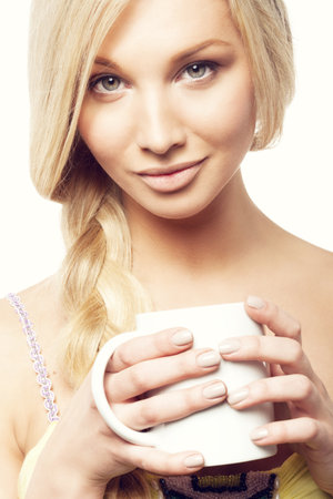 Portrait of a beautiful girl holding white cap, not isolated on white backgroundの写真素材