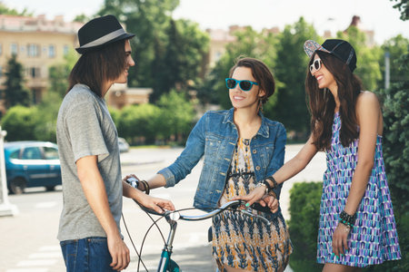 Two girls communicate with a guyの写真素材