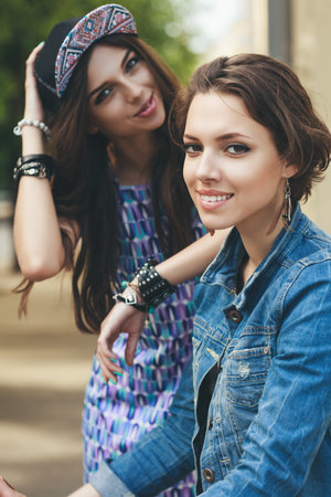 Two happy girls looking at the camera on the urban backgroundの写真素材