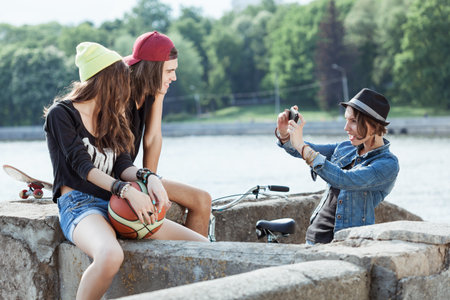 Two girls and one boy photographed in the streetの写真素材