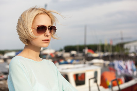 Beautiful woman on the sea and yacht background. Outdoors, lifestyleの写真素材