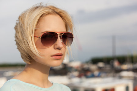 Closeup of Beautiful girl on the sea and yacht background. Outdoors, lifestyleの写真素材