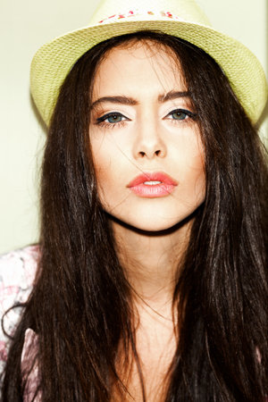 closeup of beautiful young woman in bright summer hatの写真素材