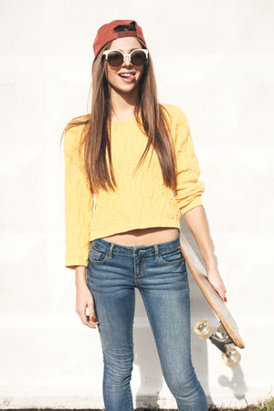Beautiful young woman  with  longboard in the afternoon. Skateboarding. Outdoors, lifestyleの写真素材