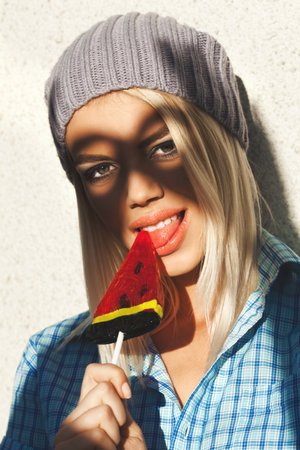 Shadow of hands forming  owl or sunglasses on face of trendy young woman. Outdoors, lifestyle.の写真素材