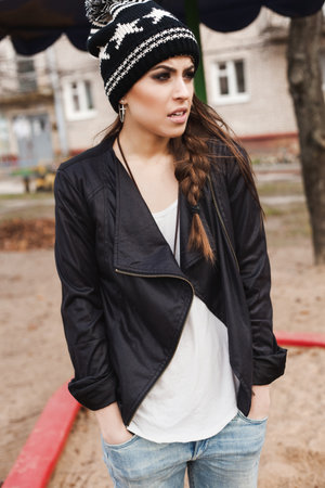 fashionable stylish girl in black beanie and leather jacket. Outdoors, lifestyleの写真素材