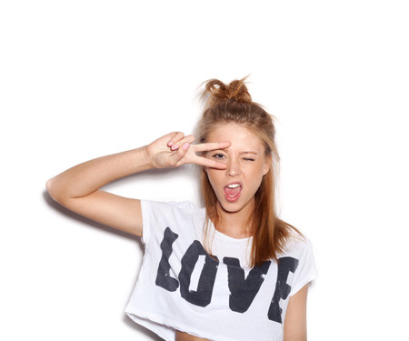 Young woman saluting and winking. の写真素材