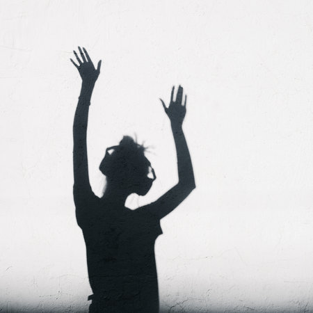 Woman with headphones lifting her hands up. の写真素材