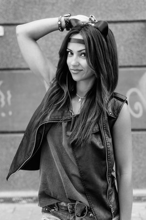 Bad girl with leather cat ears. Urban scene. Outdoor lifestyle black white portrait