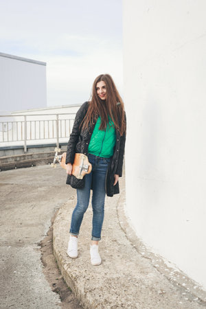 Beautiful young woman  with  longboard in the afternoon. Skateboarding. Outdoors, lifestyleの写真素材