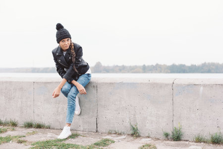 Beautiful young girl in black beanie. Outdoor lifestyle portrait of woman
