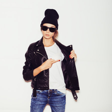 Young woman showing middle finger over white background, toned, not isolated