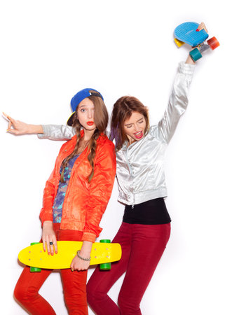 Two young girl friends standing having fun together.  Beautiful woman opening Mouth. Emotion.  Hairstyle. Makeup.  White background, not isolatedの写真素材