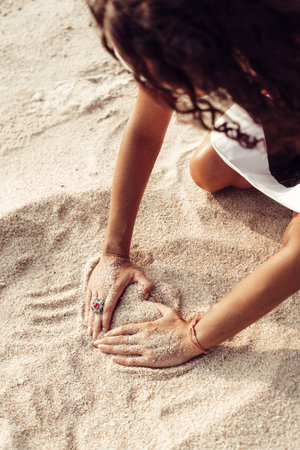 Woman hands holding sand on the beach. Outdoors lifestyleの写真素材