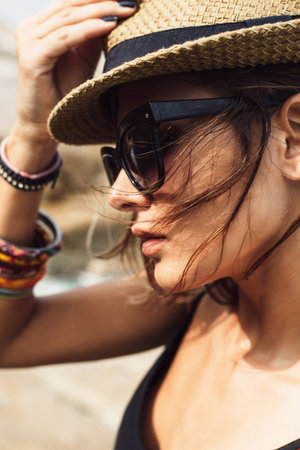 young summer girl wearing a hat  and sunglasses. Outdoors lifestyle portraitの写真素材
