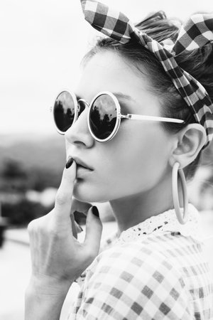 Fashion photo of sexy beautiful Girl in plaid shirt and sunglasses. Outdoors lifestyle portraitの写真素材