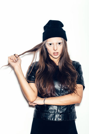 young teenage girl in black beanie for a fear or Halloween concept. White background, not isolatedの写真素材