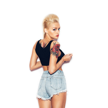 Fashion swag sexy blonde young girl posing and looking at camera.  White background, not isolatedの写真素材