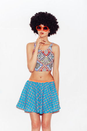 Funny cute woman in sunglasses and black wig. White backgroundの写真素材