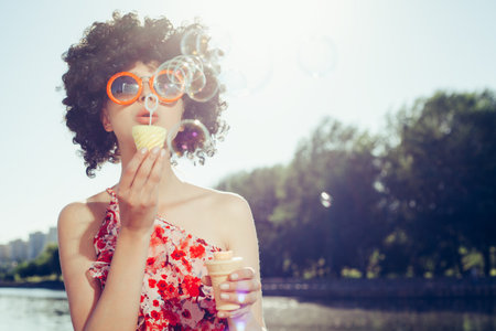 Vintage photo of soap bubble blower woman. Outdoors lifestyleの写真素材
