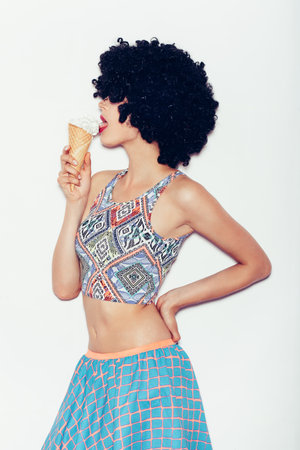 young woman eating ice cream over White backgroundの写真素材