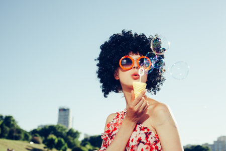 Vintage photo of soap bubble blower woman. Outdoors lifestyleの写真素材