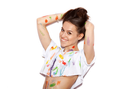 Young cheerful soiled in paint girl with long hair having funの写真素材