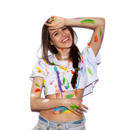 Young cheerful soiled in paint girl having funの写真素材