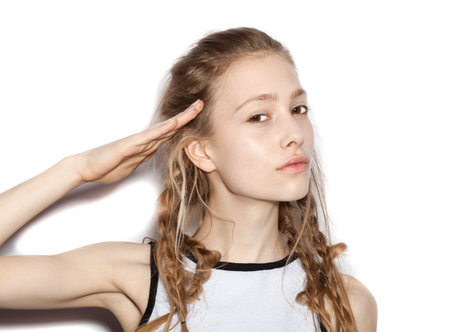 Closeup of  Fashion girl hipster with pigtails saluting.  White background, not isolatedの写真素材