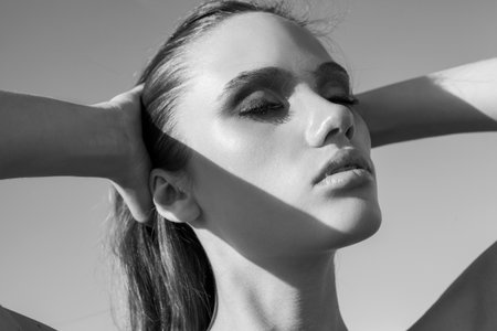 Beauty Sunshine Girl Portrait. Pretty happy woman enjoying summer outdoors. Sunny Summer Day under the Hot Sunの写真素材