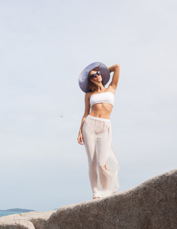 fashion portrait of Young pretty female model on the sea. Outdoors lifestyle portraitの写真素材