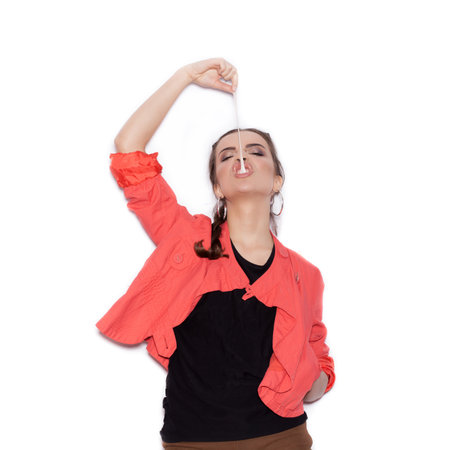 Beautiful brunette woman. Fashion portrait on white background not isolated. Chewing bubble gum