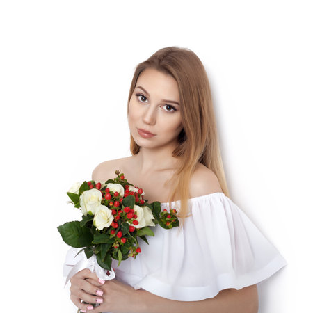 Beauty Fashion Model Woman with big Bouquet of flowers. Portrait with the Bunch of Red Rose flowers. Red Lips. Beautiful Brunette Girl with Luxury Makeup, perfect skin. Not isolated on white backgroundの写真素材